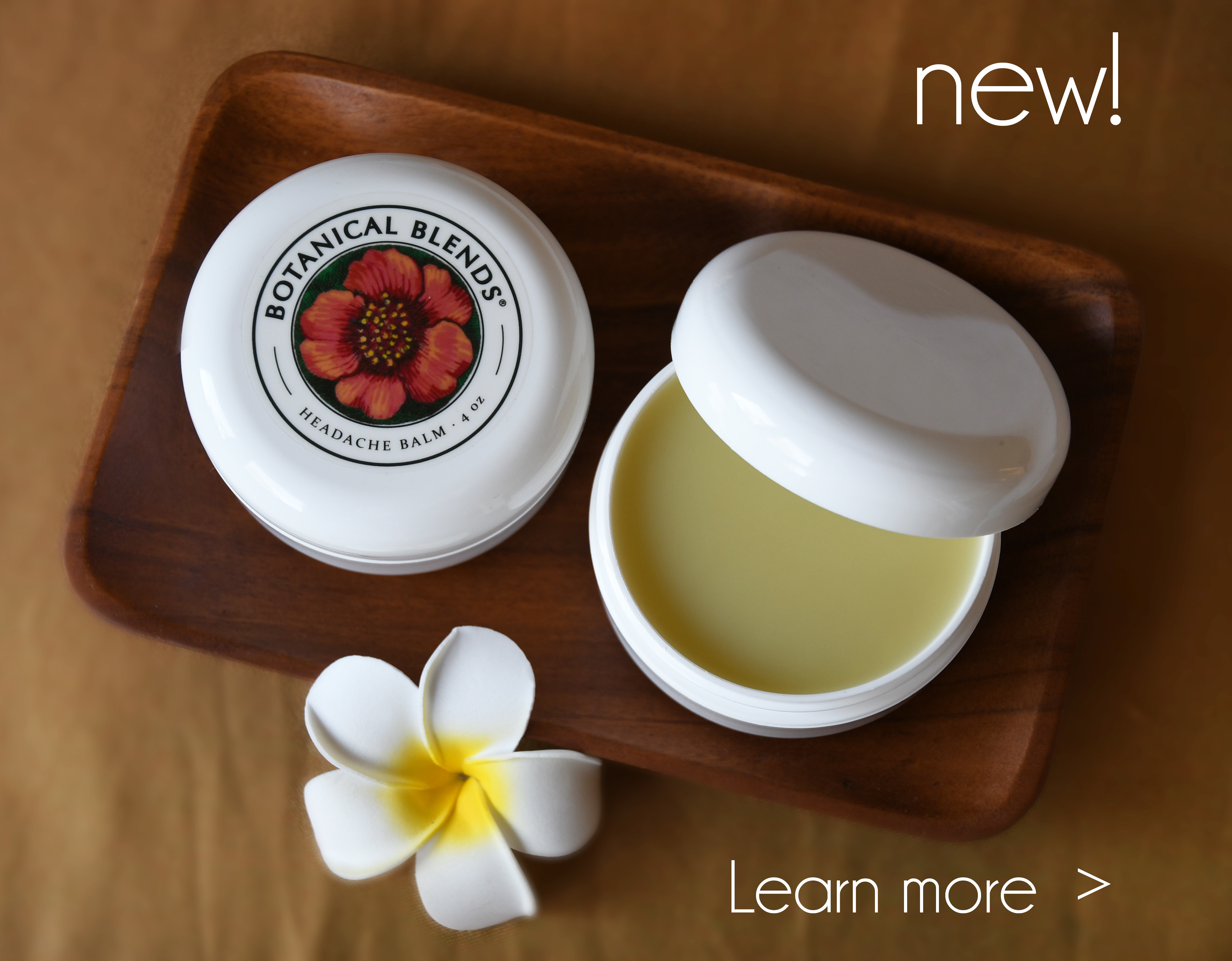 4oz container of headache balm on wooden plate with a white flower